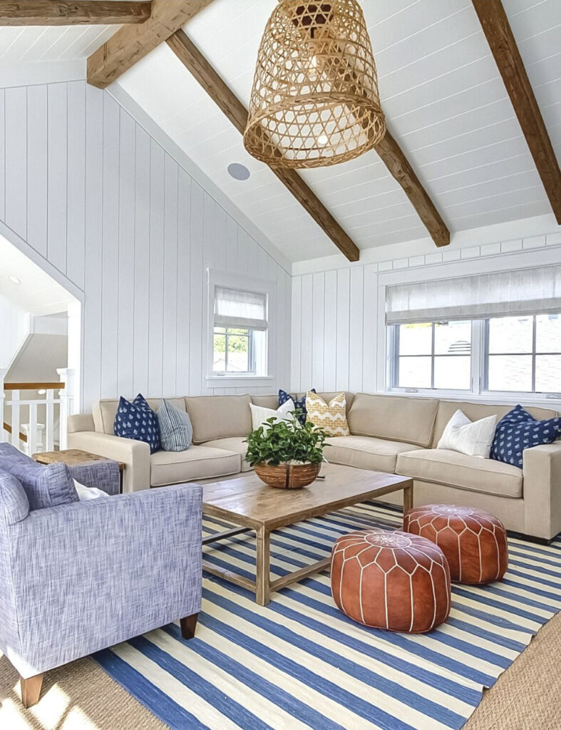 family room with exposed ceiling beams and striped rug