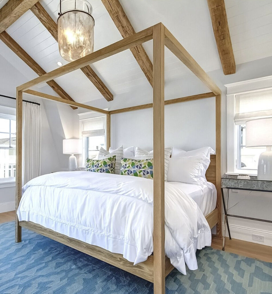 bedroom with ceiling beams and bed pillars