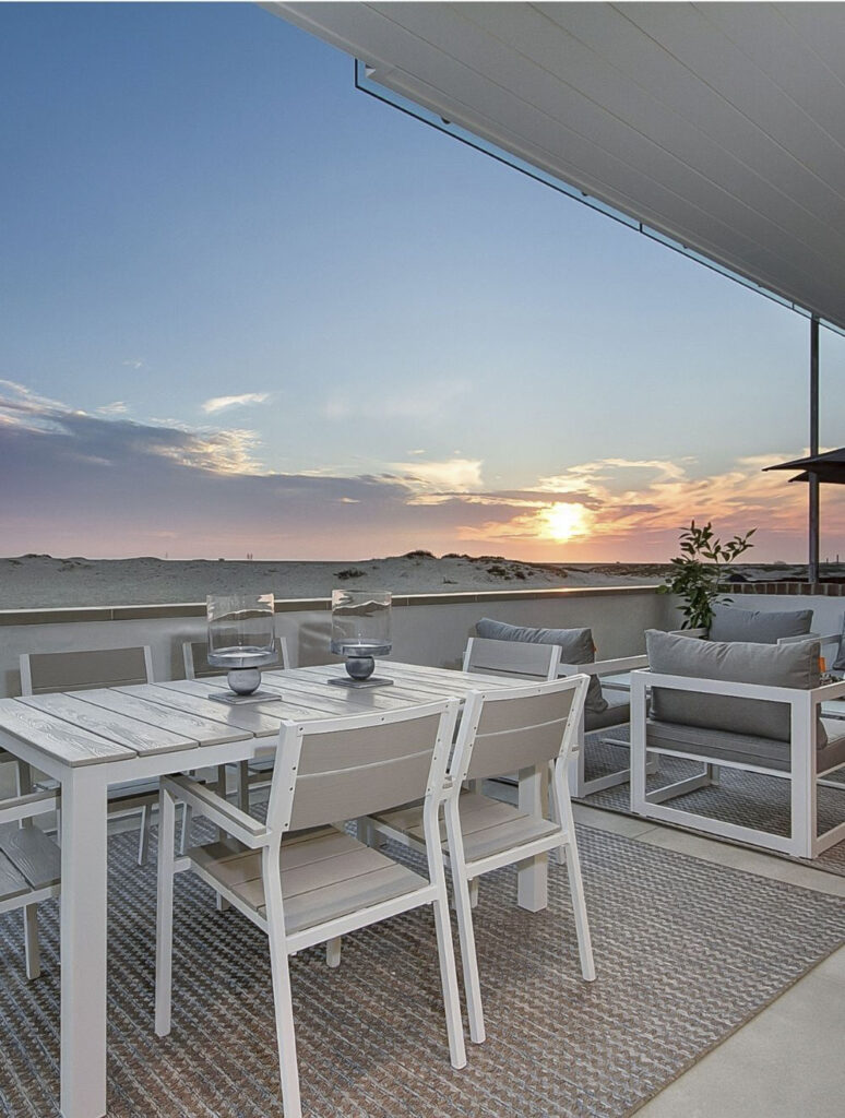 patio with view of sunset and beach